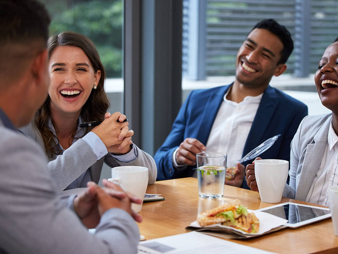 Happy, business people and collaboration for morning, meeting and breakfast in conference room. Men, women and diversity in office with pride, teamwork and group for discussion and international job